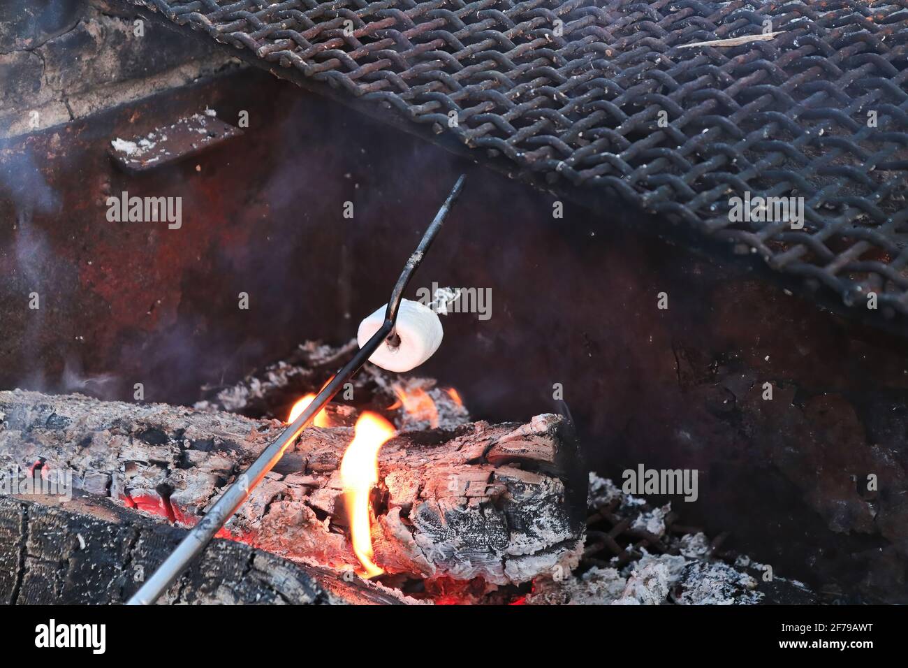 Kochen einer Marschmalche mit einem String mit zwei Zapfen Stockfoto