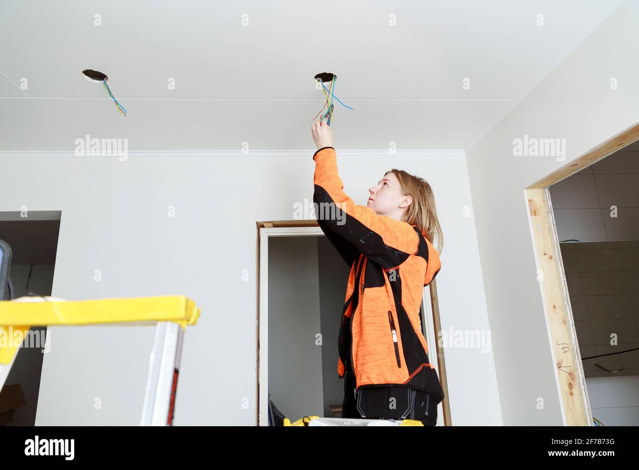 Junge Frau, die das Haus renoviert Stockfoto