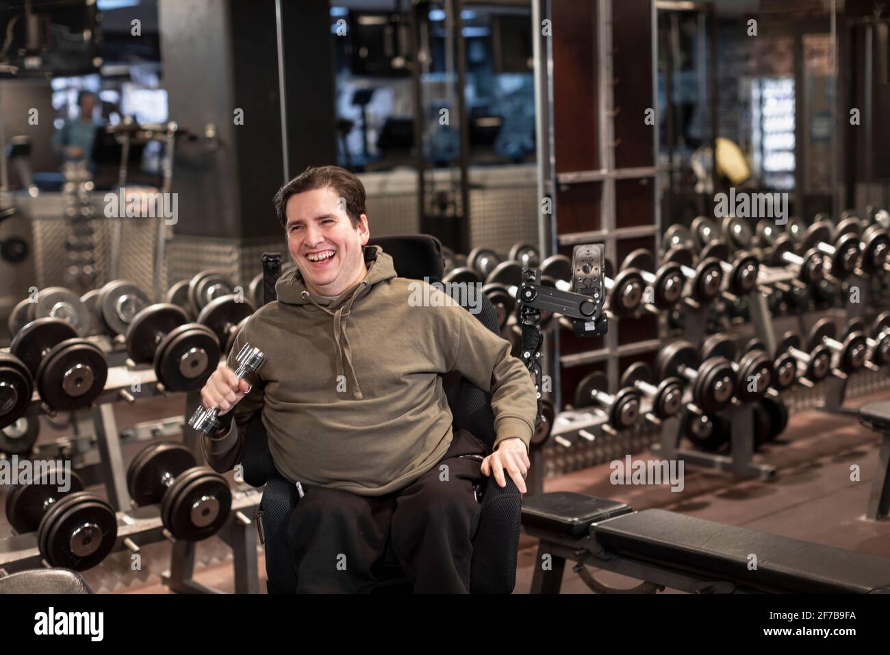 Mann im Rollstuhl trainiert im Fitnessstudio Stockfoto