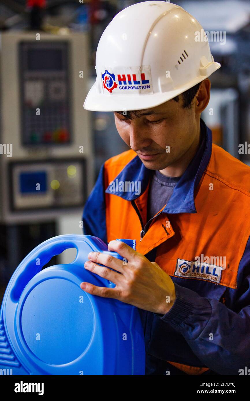 Motoröl moderne Produktionsanlage. Arbeiter mit Plastikkanister (Plastikkanister). Qualitätskontrolle von Stanzen. Stockfoto