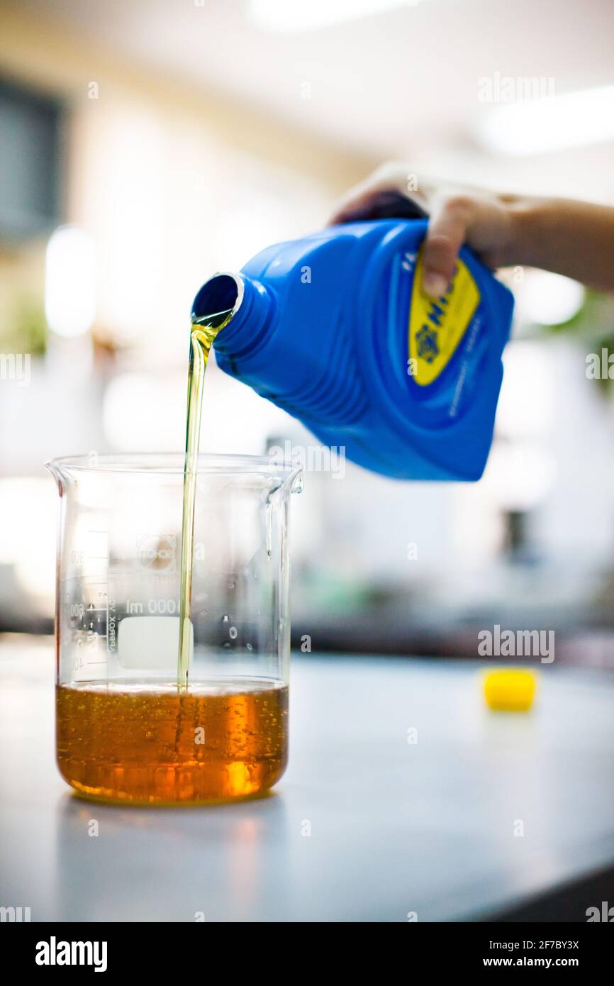 Shymkent/Kasachstan - April 26 2012: Moderne Produktionsanlage für Motoröl. Chemielabor, Öl, das vom Kunststoffbehälter zum Glasdeckel fließt. L Stockfoto