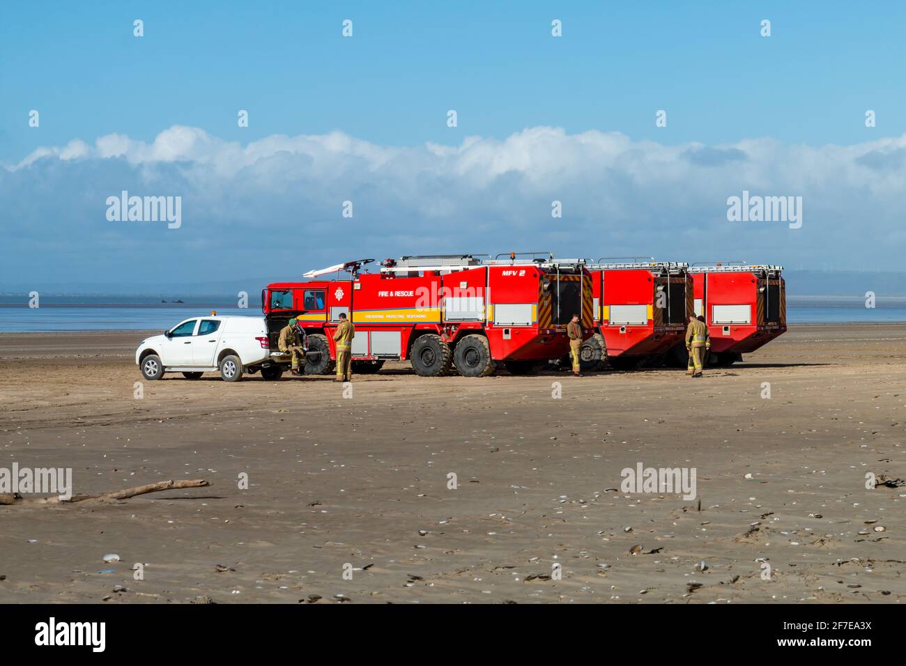 CEFN SIDAN, WALES - MÄRZ 25 2021: Mehrere Flughafen-Feuerwehrautos bieten Sicherheitsschutz für die Royal Air Force, die taktische Strandlandungen praktiziert Stockfoto
