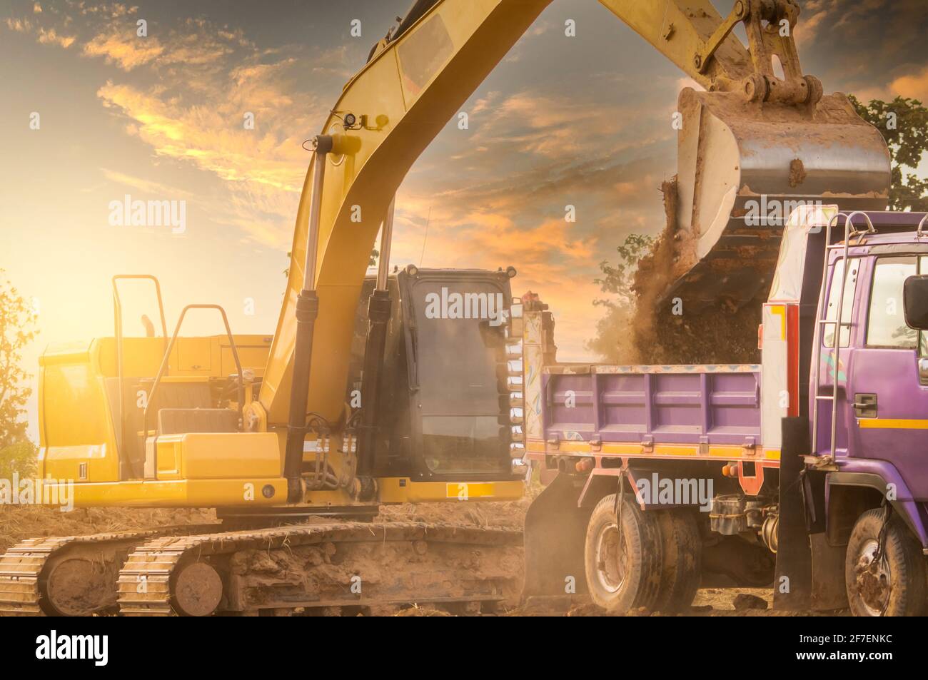 Baggerarbeiten durch Erdarbeiten auf der Baustelle und Verladung an den LKW. Eimer mit Baggerlader transportieren Erde zum LKW. Raupenbagger Dump Schmutz Stockfoto