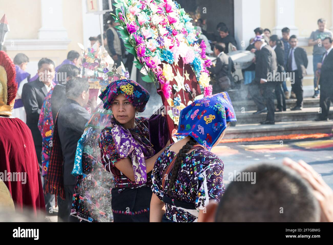 Indigene guatemaltekische Frauen in traditioneller Kleidung verbrennen Weihrauch während der Semana Santa Prozession in Antigua, einem feierlichen Ritual voller Geschichte. Stockfoto