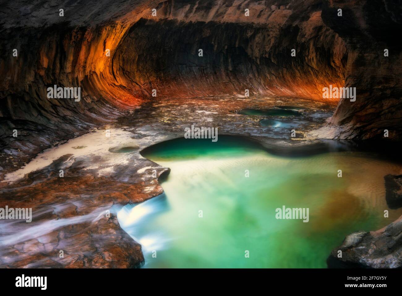 Reflektierendes Licht beleuchtet die Labyrinth-Schlitzschluchtwände der Subway mit ihren smaragdgrünen Pools im Zion National Park. Stockfoto