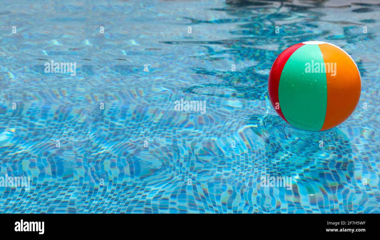 Beachball im Pool. Bunte aufblasbare Kugel schwimmt im Schwimmbad. Stockfoto