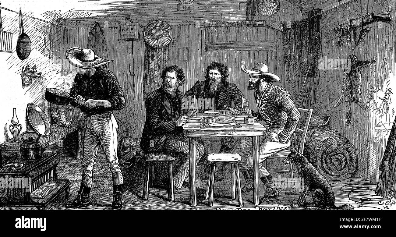 Ein Team von Pionieren teilt sich eine Mahlzeit in einer rustikalen Hütte an der amerikanischen Grenze. Stockfoto