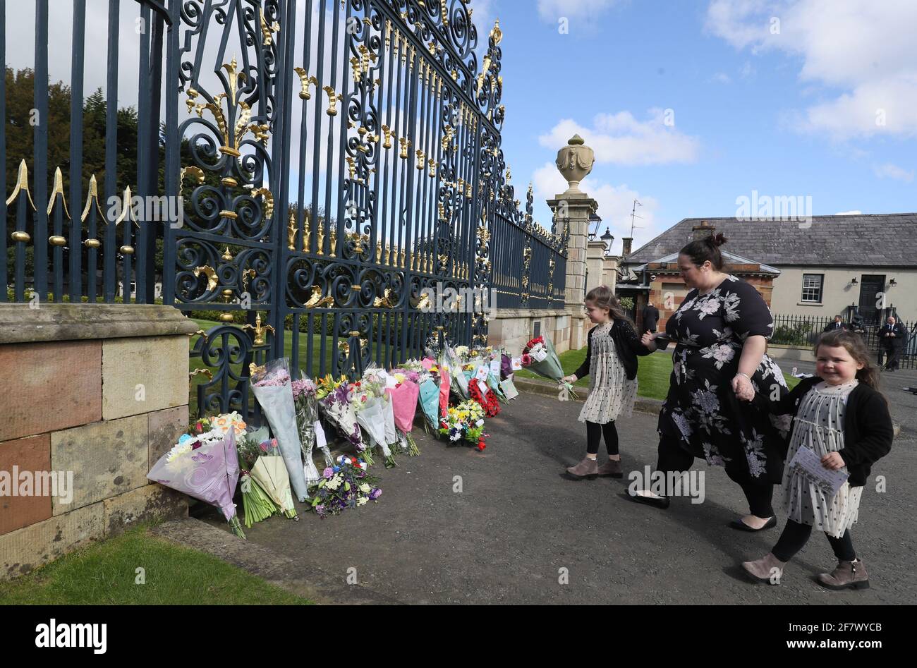 Naomi Armstrong-Cotter und ihre Töchter Lillie, 6, (links) und Essie, 5, kommen nach der Ankündigung des Todes des Herzogs von Edinburgh im Alter von 99 Jahren an den Toren des Hillsborough Castle in Nordirland an, um Blumen zu legen. Bilddatum: Samstag, 10. April 2021. Stockfoto