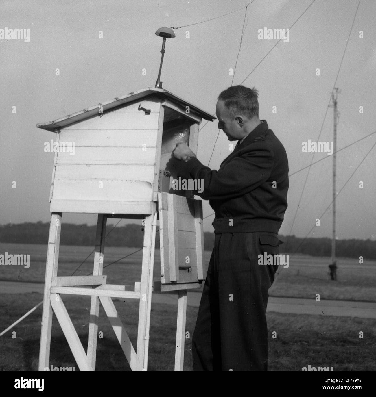 Major J. H. Landwirt, Chefkoch Meteorologischer Dienst des Luftwaffenstützpunktes Woensdrecht auf der Meteo-Hütte, in der ein Blitzzähler aufgestellt wird. Im Hintergrund eine der Antennen. Stockfoto