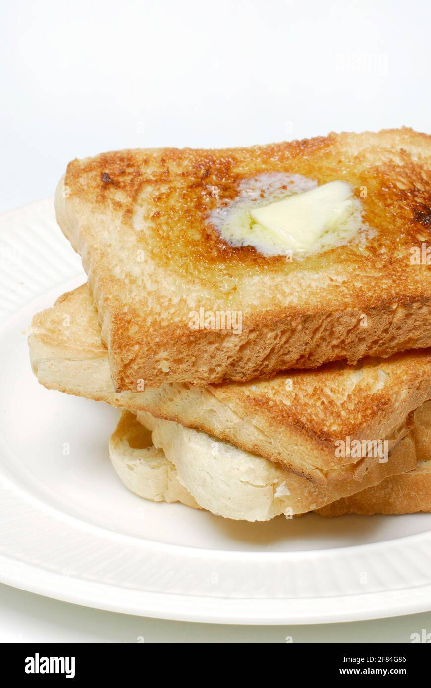 Toast mit schmelzender Butter, Teller Stockfoto