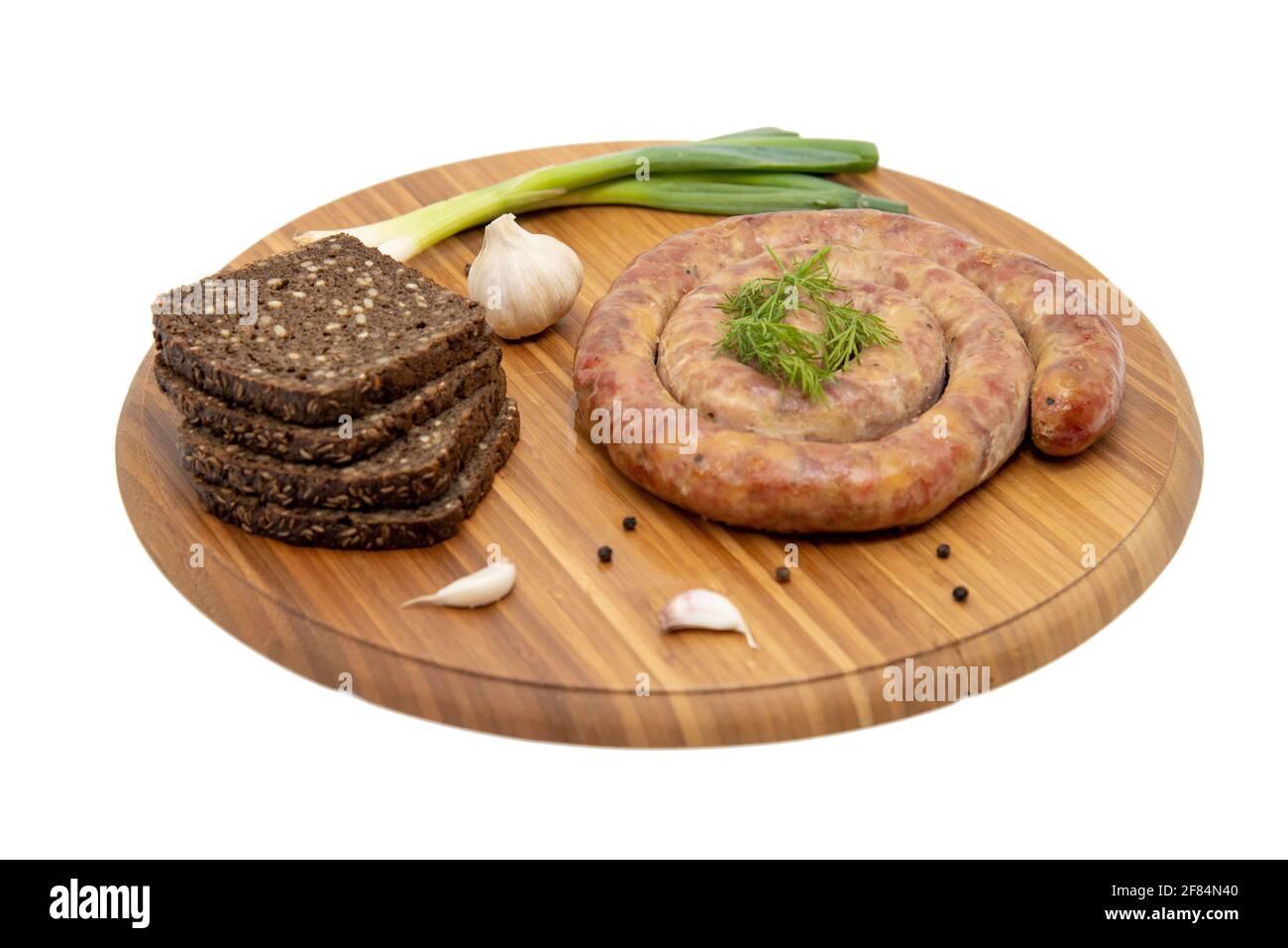 Gewickelte cumberland-Wurst mit Knoblauch rustikalem Brett Stockfoto