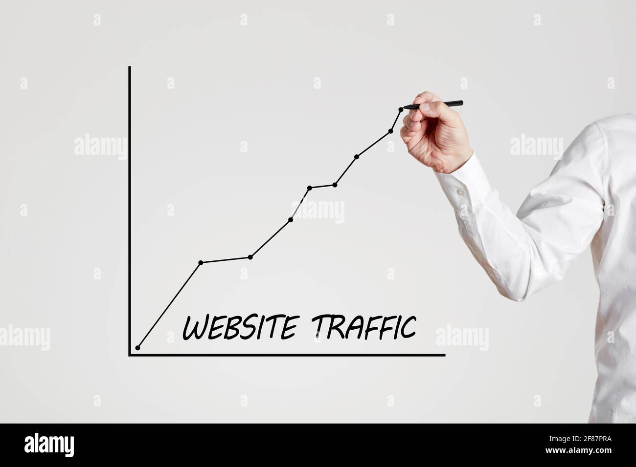 Businessman Hand zeichnet eine steigende Linie Graph mit dem Wort Website-Verkehr. Das Konzept des zunehmenden Webseitenverkehrs. Stockfoto
