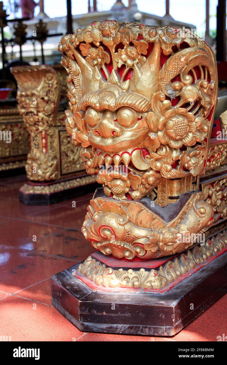 Traditionelle geschnitzte Goldstatue von Drachenwesen im Tempel in Bali, Indonesien Stockfoto