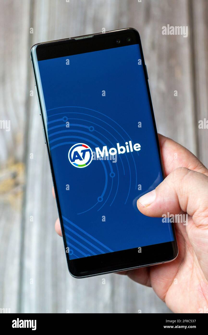 Ein Mobiltelefon oder Mobiltelefon, das in einem gehalten wird Hand mit der AT Mobile App geöffnet auf dem Bildschirm Stockfoto