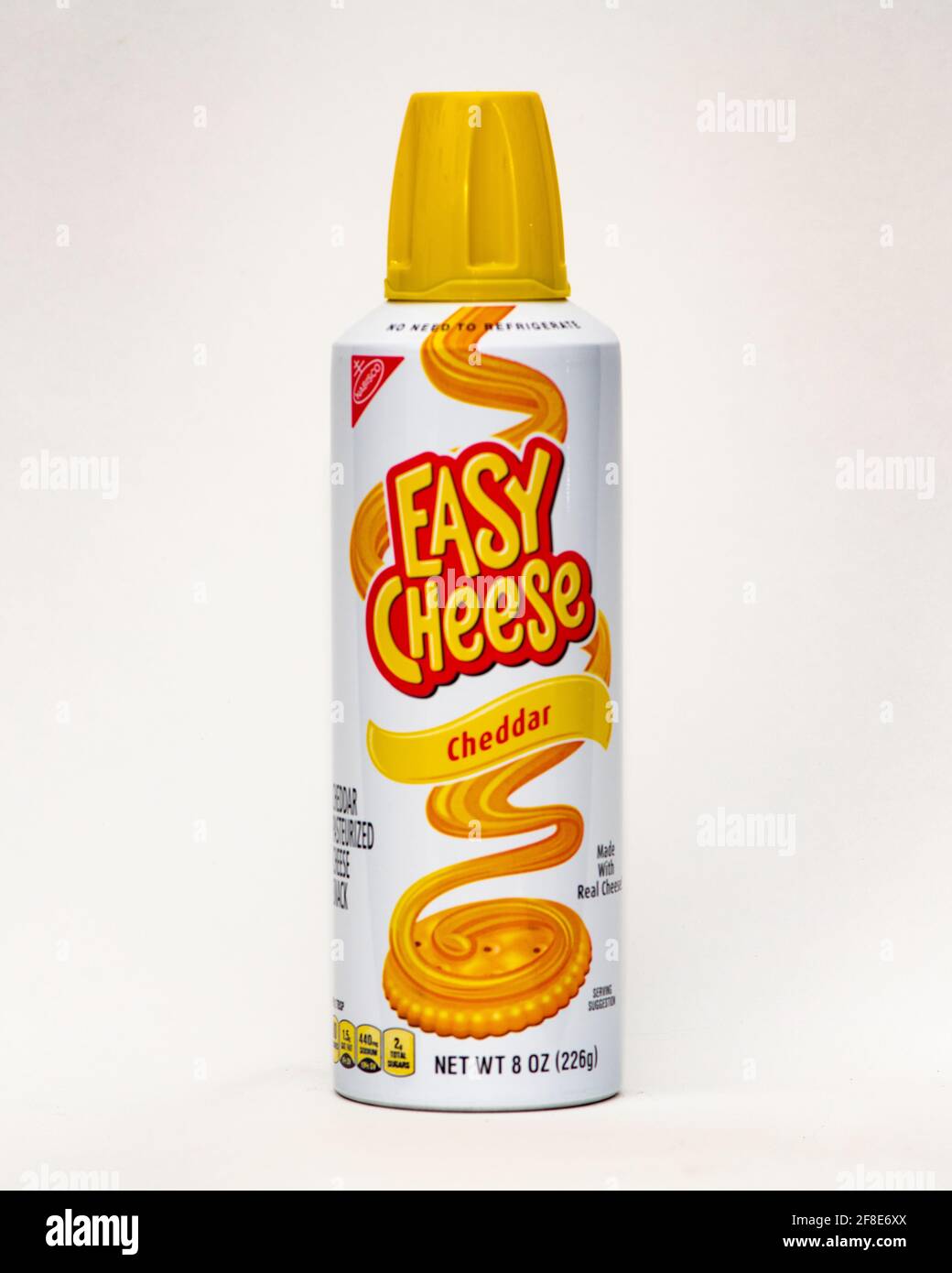 Eine unter Druck stehende Dose oder Cheddar Flavor Easy Cheese, spritzen Sie sie einfach auf einen Cracker für einen sofortigen leckeren Snack. Stockfoto