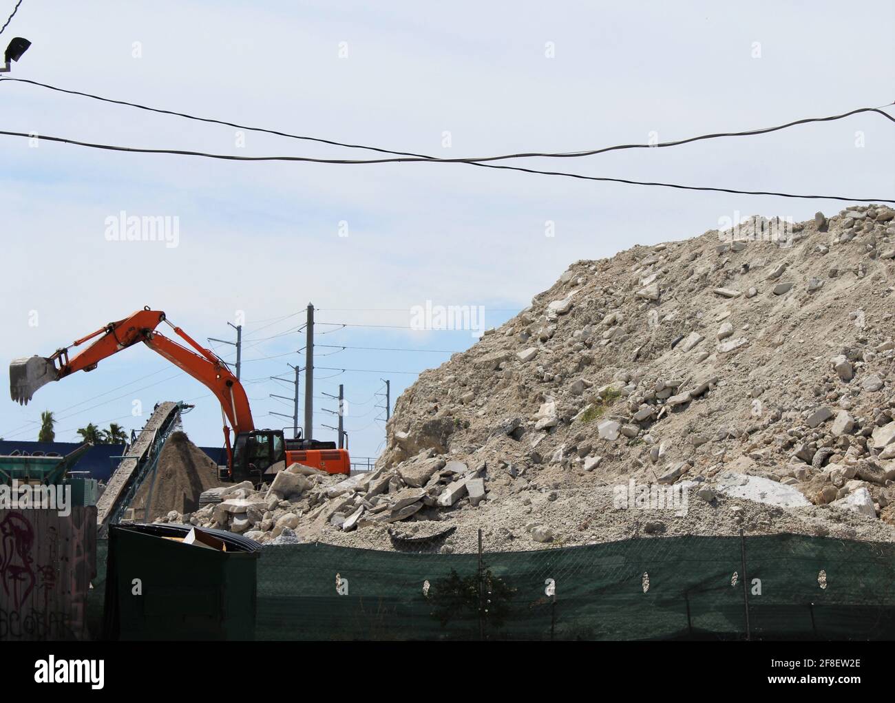 Haufen von Schotter auf der Baustelle. Ein großer, kraftvoller Lader überlädt einen Schutthaufen in einer Betonanlage. Stockfoto