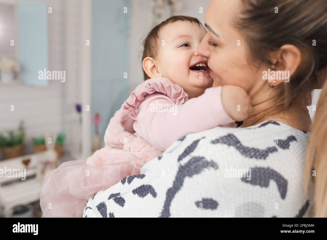 Glückliche Mutter und Tochter 1 Jahr alt frönen.Konzept der Intimität der Umarmungen und Freude der Familienbeziehungen. Close up Stockfoto