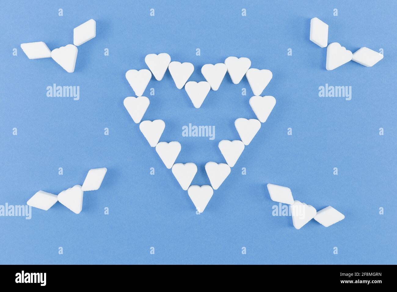 Dekor White Sugar Heart formt Blockwürfel in herzförmiger Form mit Engeln auf blauem Hintergrund. Ich liebe das süße Konzept Stockfoto