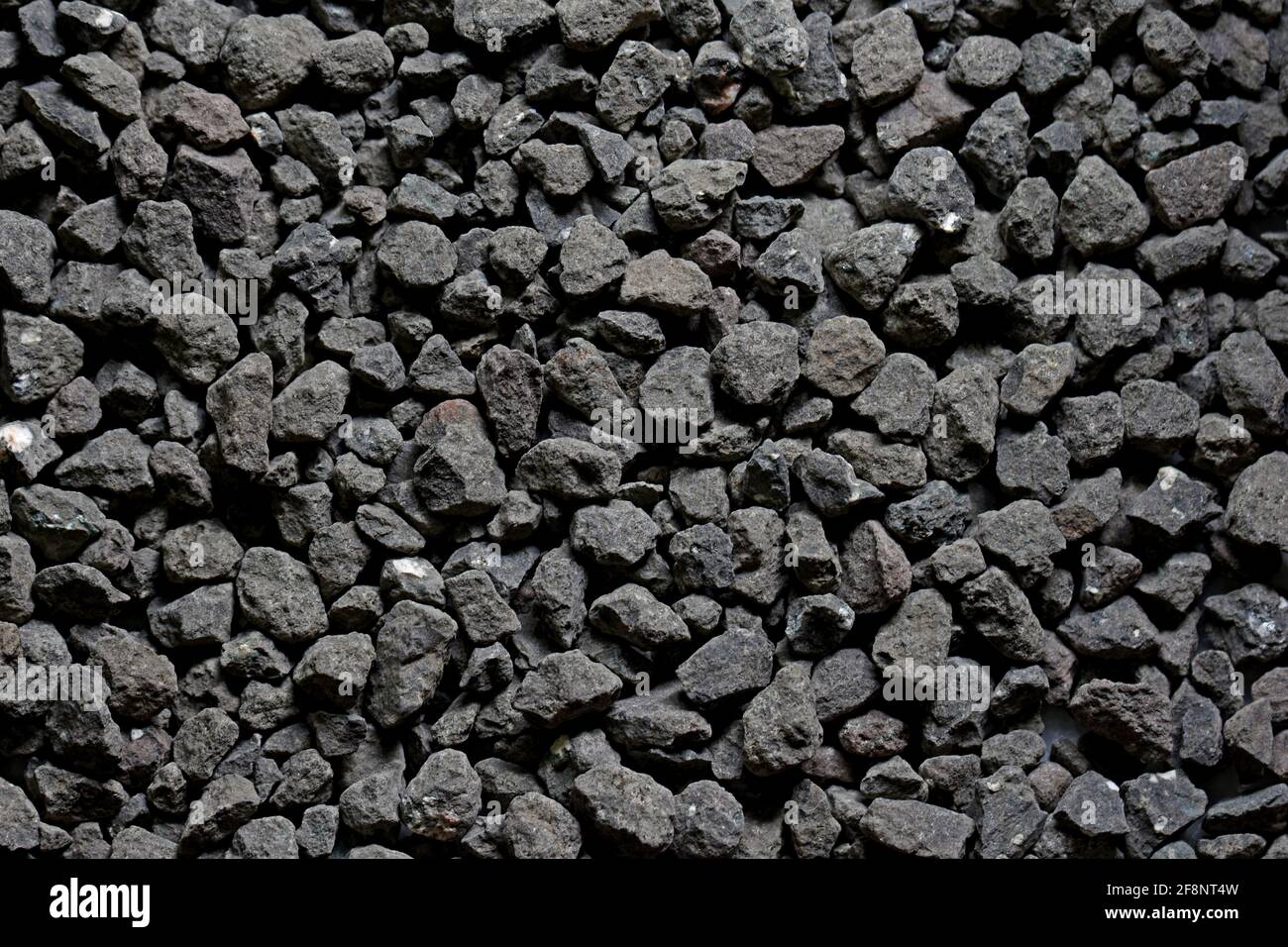 Schwarze kleine Straße Stein Hintergrund, dunkle Kies Kieselsteine Stein Textur nahtlose Textur, Stockfoto