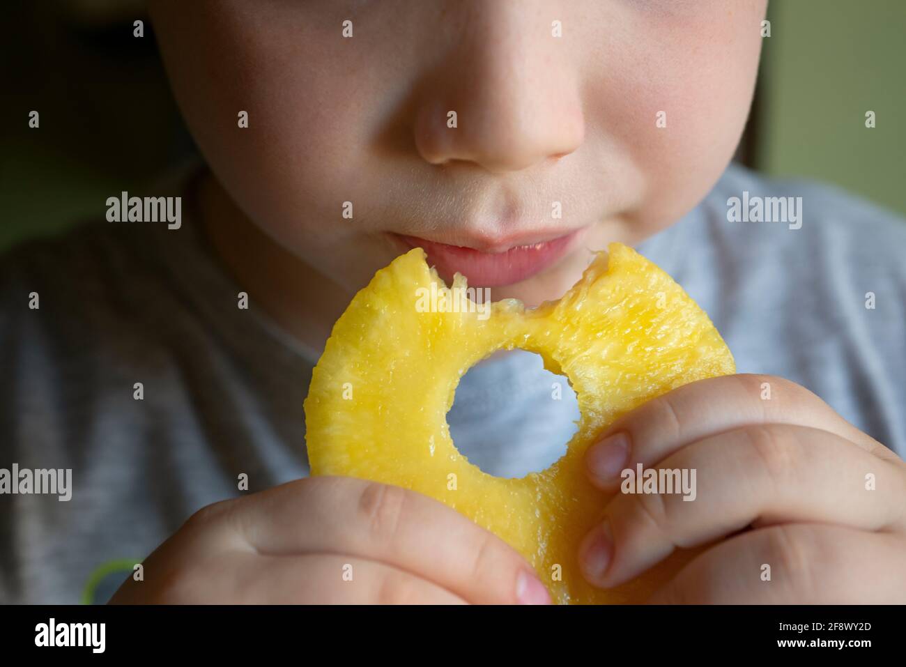Lttle Boy, der Ananas isst Stockfoto