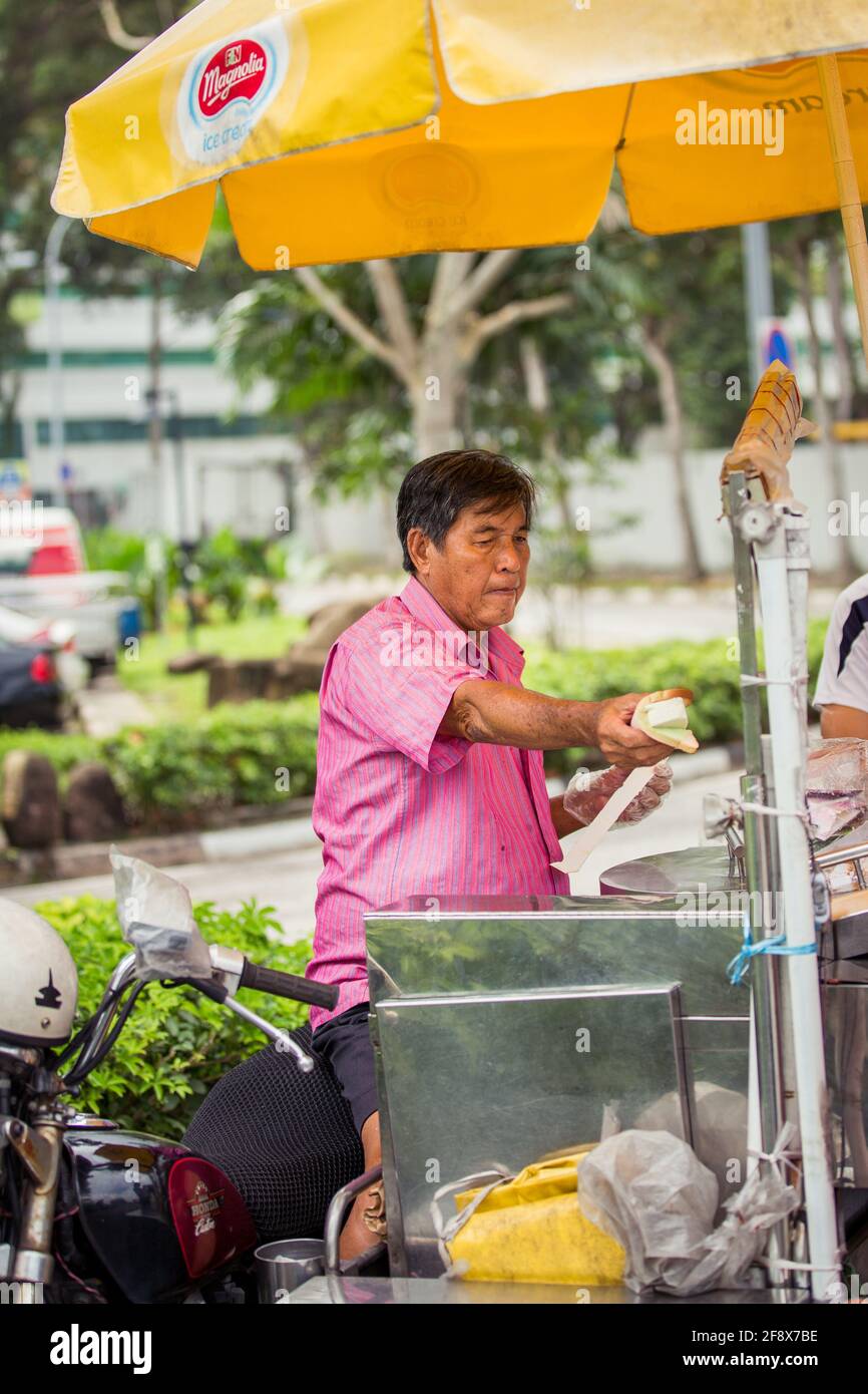 Singapur, Singapur - 4. Januar 2014: Ein Straßenverkäufer, der Eisdielen in einer Straße in Singapur verkauft. Stockfoto