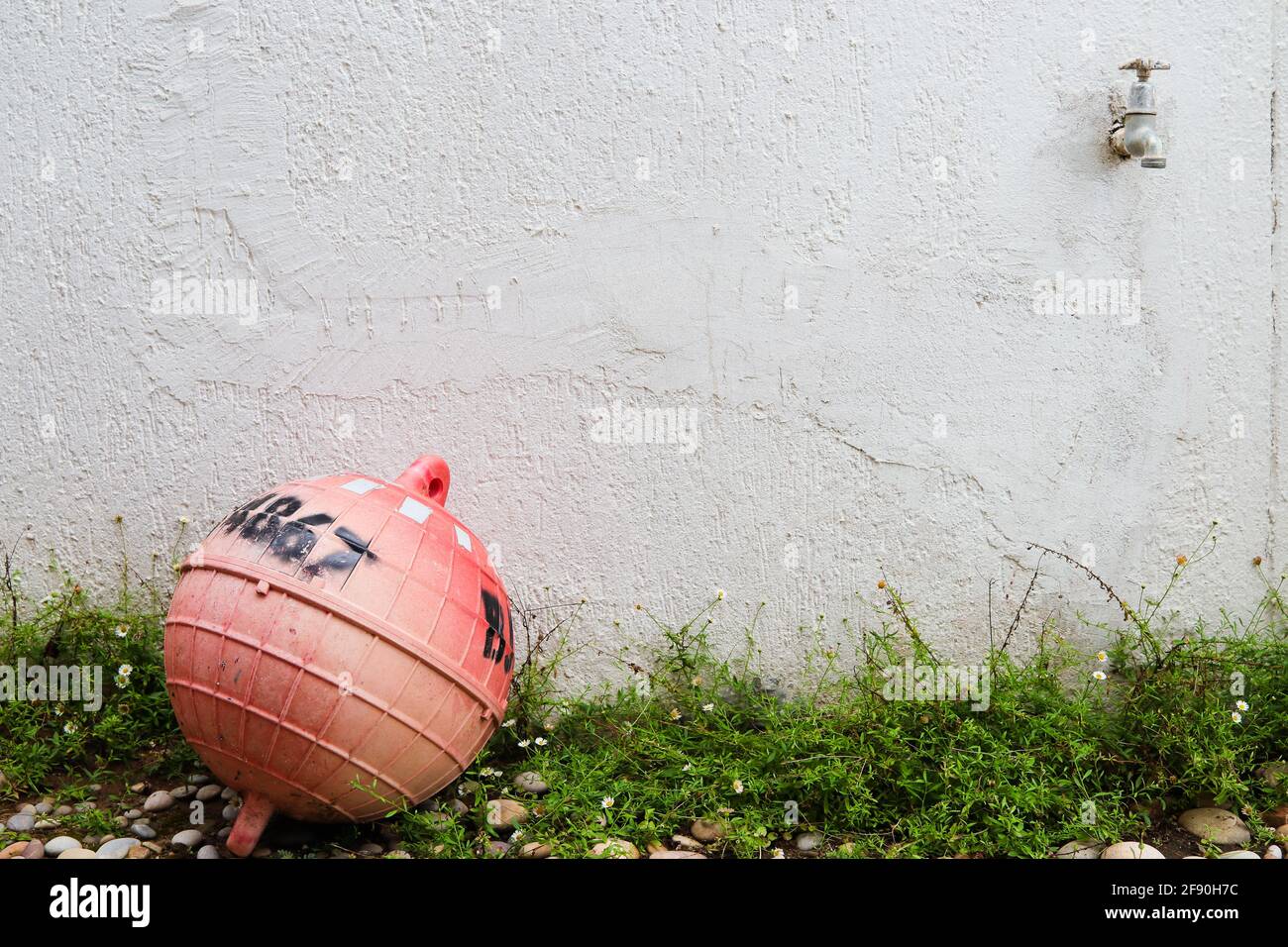 Verputzte Weiße Wand Mit Wasserhahn Und Boje Stockfoto