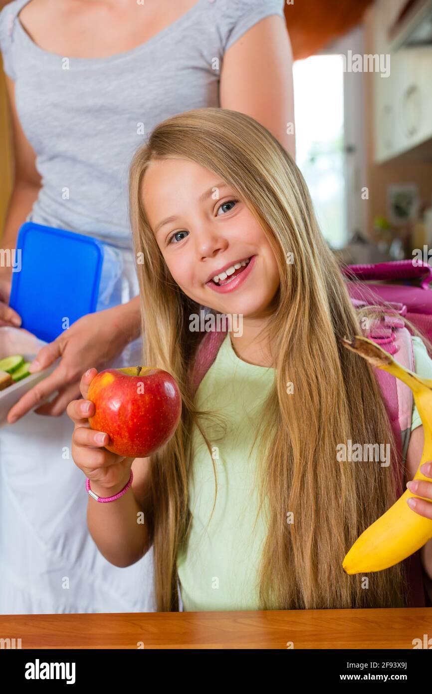 Familie - Mutter, die Zubereitung von Frühstück am Morgen und einen Snack für die Schule für ihre Kinder Stockfoto