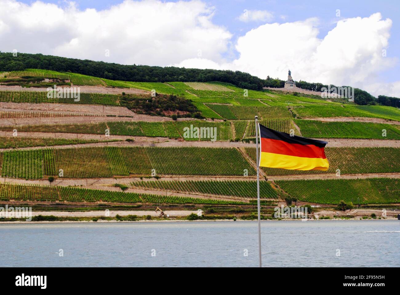 Rhein, deutsche Flagge und Weinberge. Niederwalddenkmal, Germania-Statue, Denkmal der Wiedervereinigung steht auf dem Hügel in Rüdesheim am Rhein, Deutschland Stockfoto