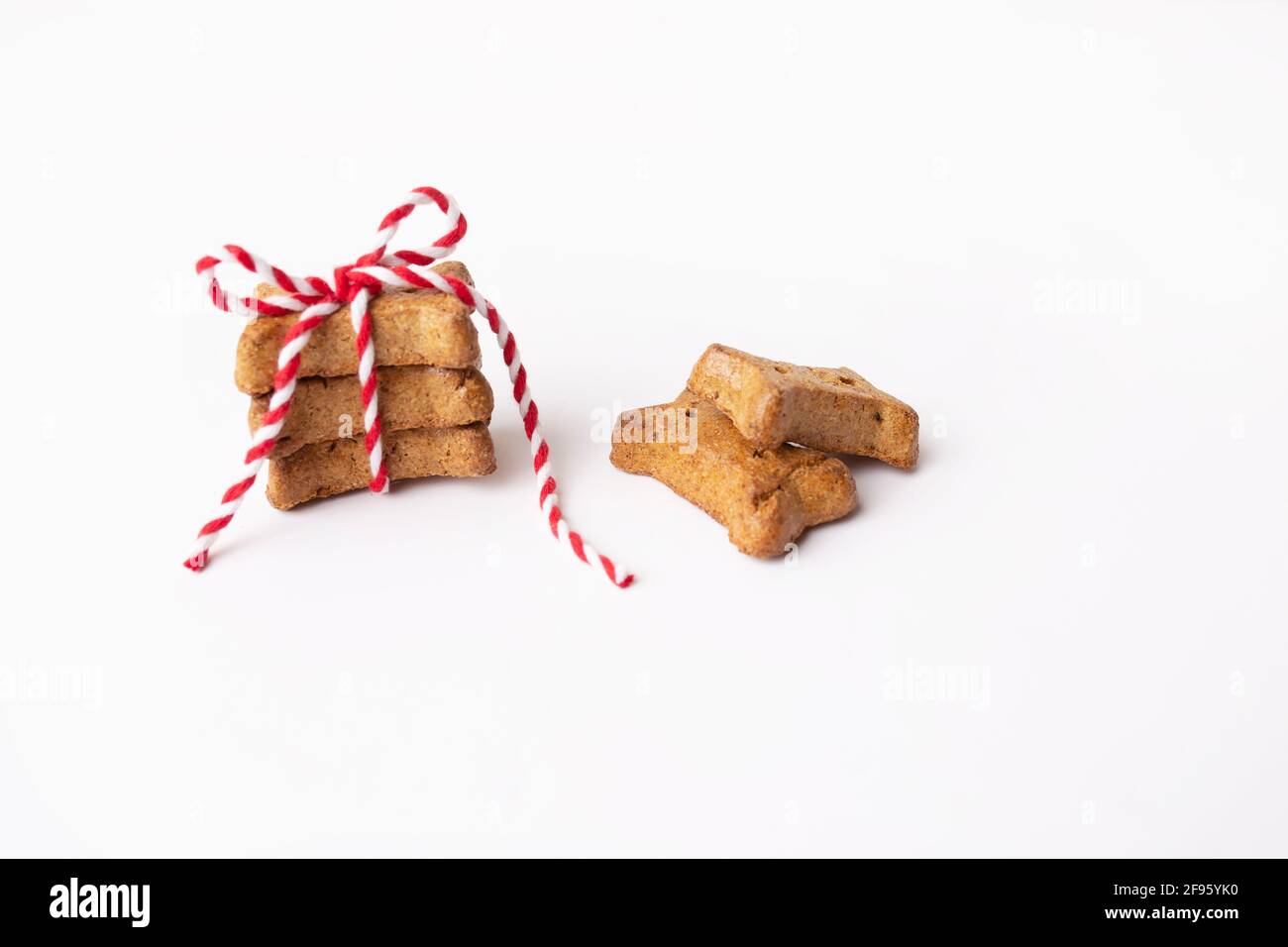 Horizontales Bild von braunen Hundeleckereien, die in das Garn des Bäckers gebunden sind Auf Weiß Stockfoto