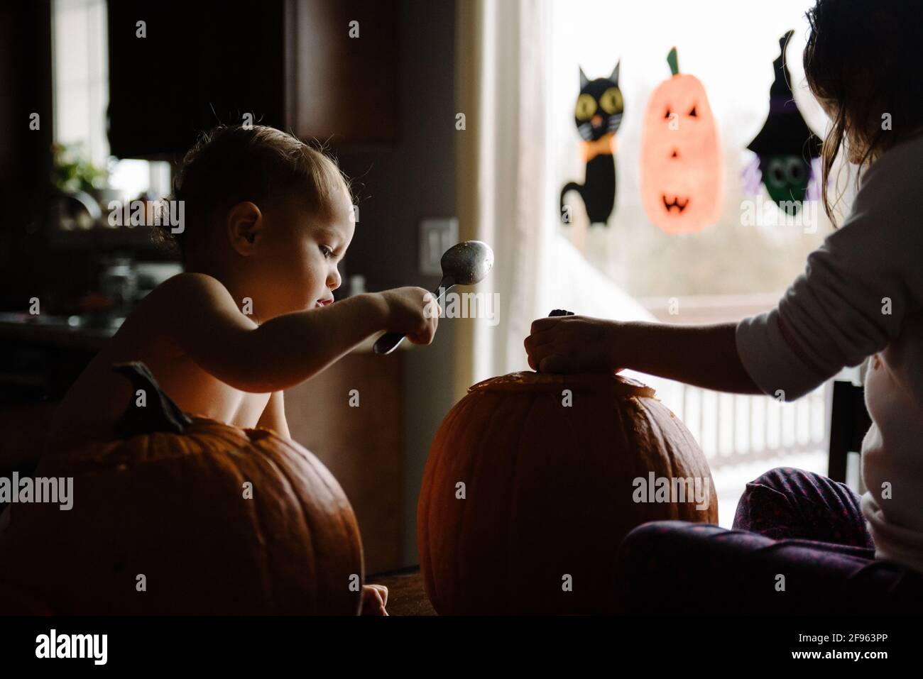 Zwei Kinder Kürbis schnitzen an halloween in ihrem Zuhause Stockfoto