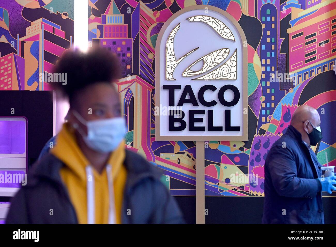 New York, USA. April 2021. Innenansicht des „Digital Only“-Kantinenrestaurants von Taco Bell an der 7th Avenue am Times Square, New York, NY, 16. April 2021. Die Kunden haben Zugriff auf zehn Touchscreen-Menüs, über die sie ihre Lebensmittelbestellungen mit möglichst geringem Kontakt mit Menschen aufgeben und bezahlen können. Die Kunden lassen sich bei der Eingabe die Temperatur überprüfen und werden gebeten, sich für die Kontaktverfolgung in einem Buch zu registrieren. (Foto von Anthony Behar/Sipa USA) Quelle: SIPA USA/Alamy Live News Stockfoto