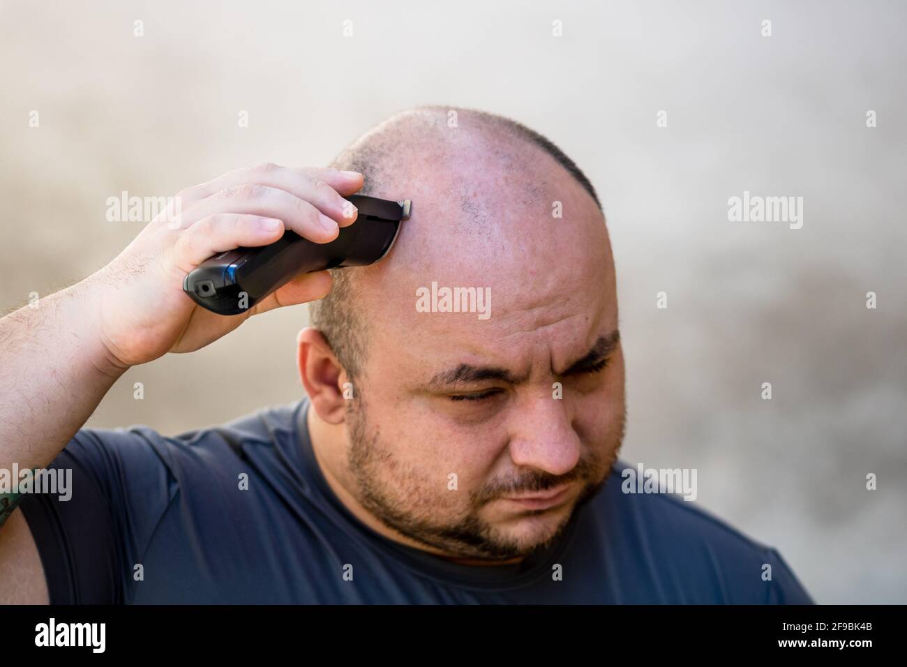 Männer rasieren oder trimmen ihre Haare mit einem Haarschneider Oder  Elektrorasierer Stockfotografie - Alamy