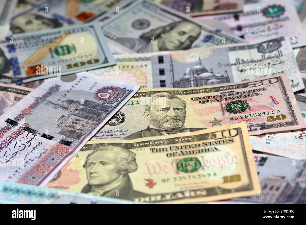 Ägyptische Landeswährung mit US-Dollar-Banknoten im Hintergrund. Geldscheine. Ägyptische Pfund-Banknoten und amerikanische Dollar-Rechnungen Hintergrund. Stockfoto