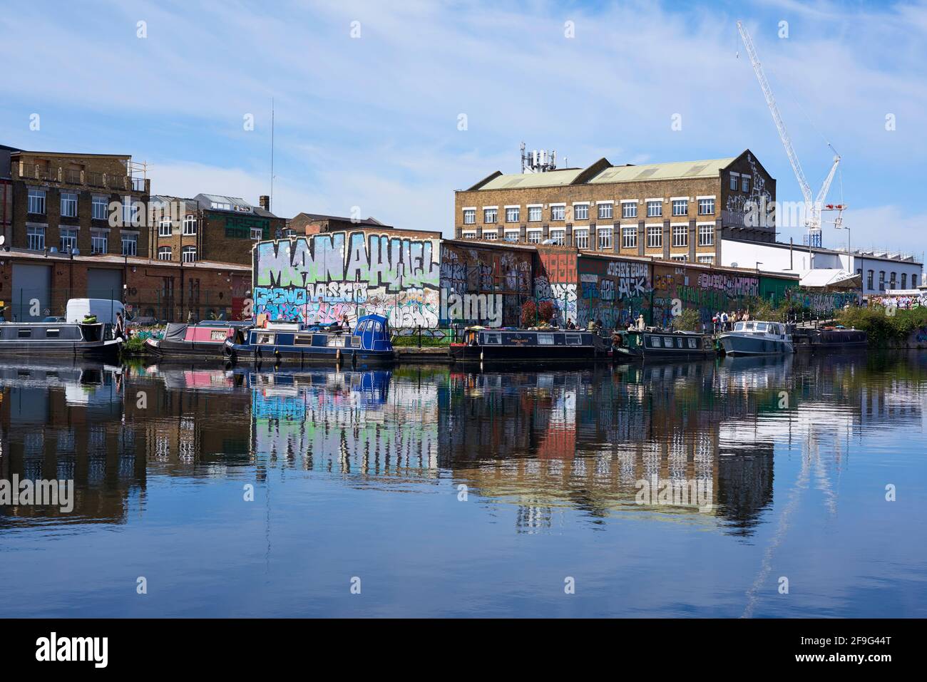 Narrowboote und Gebäude entlang des Flusses Lea Navigation in Hackney Wick, East London, Großbritannien Stockfoto