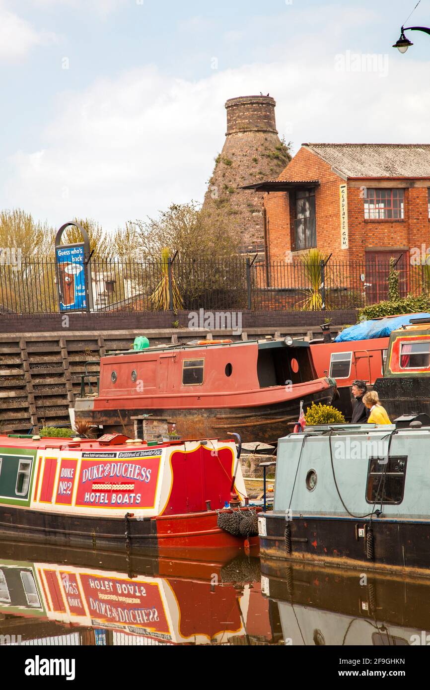 Narrowboats auf dem Trent und Mersey Kanal bei Longport Boot Yard Stoke auf Trent Staffordshire mit einem alten Flaschenofen Im Hintergrund Stockfoto