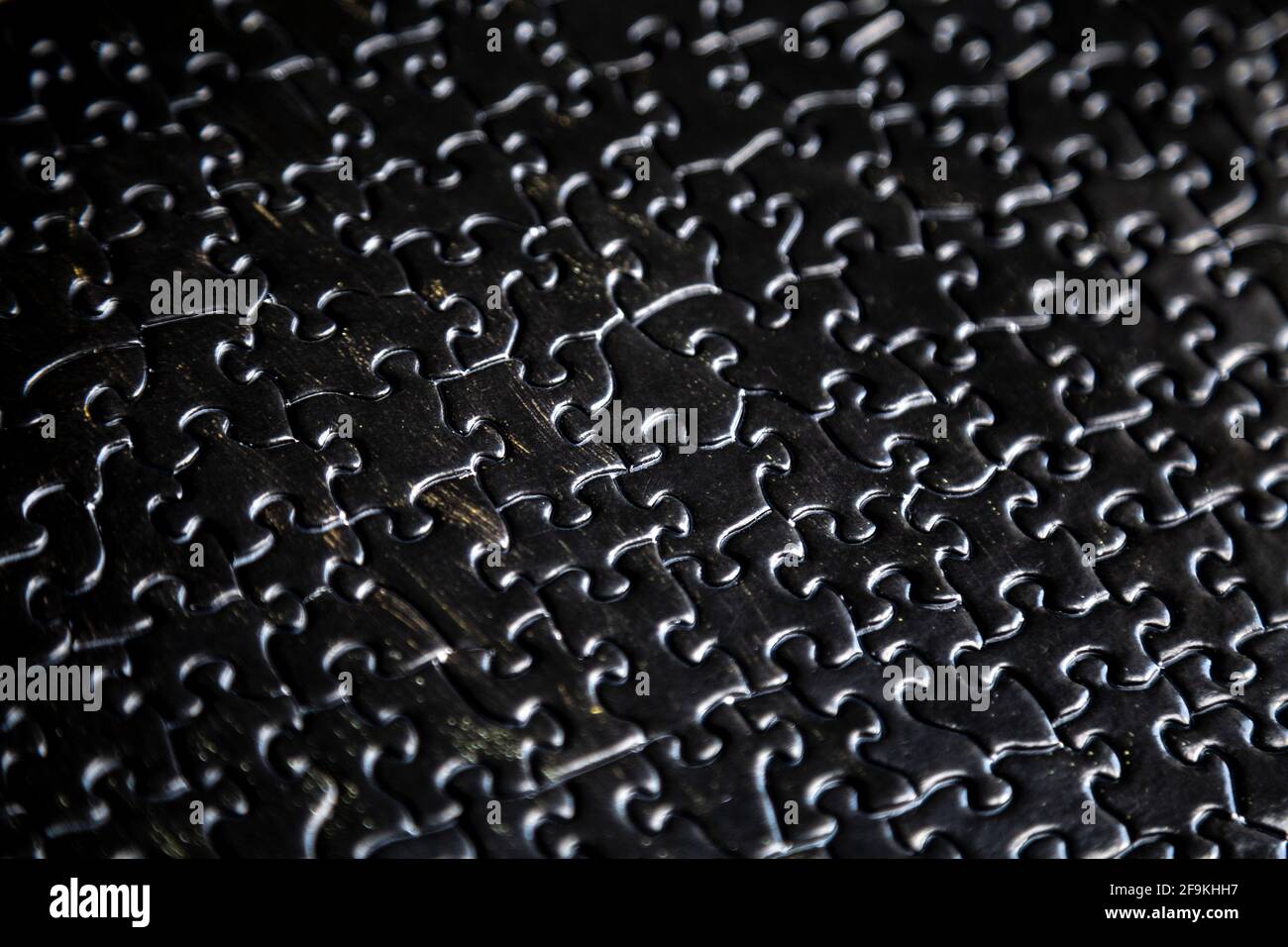 Schwarz strukturierte Puzzle-Teile Hintergrund Stockfoto