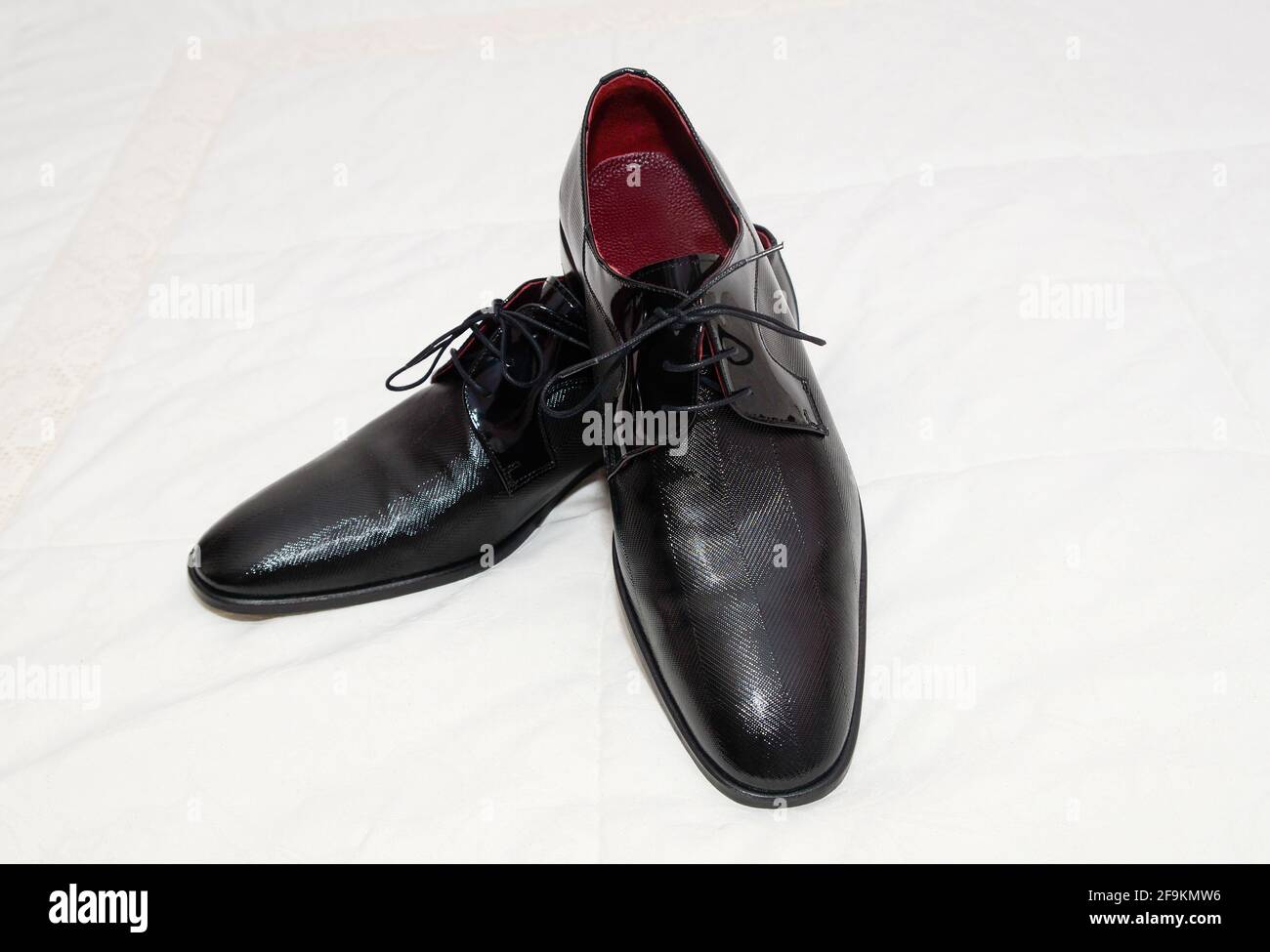 Ein Paar stylische Herrenschuhe auf einer weißen Stoffoberfläche. Stockfoto