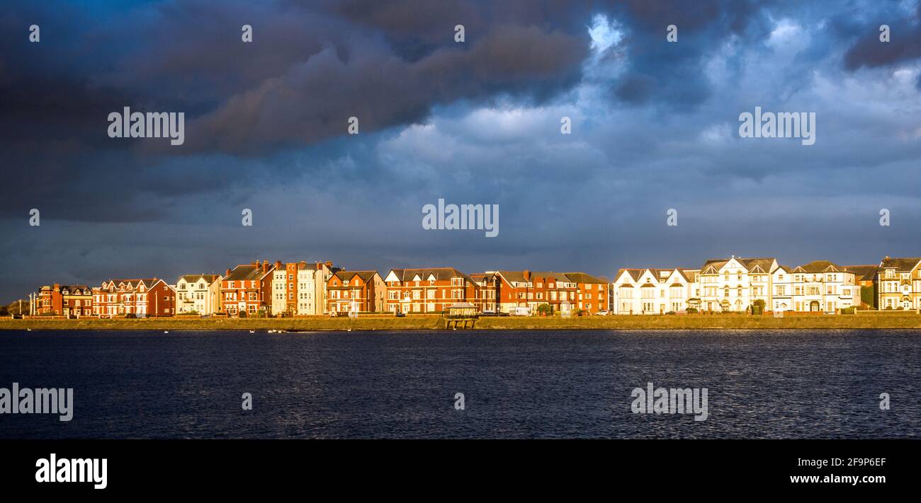 Die abendliche Sonneneinstrahlung wirkt dramatisch auf die Gebäude auf der Promenade, Southport, Großbritannien. Stockfoto