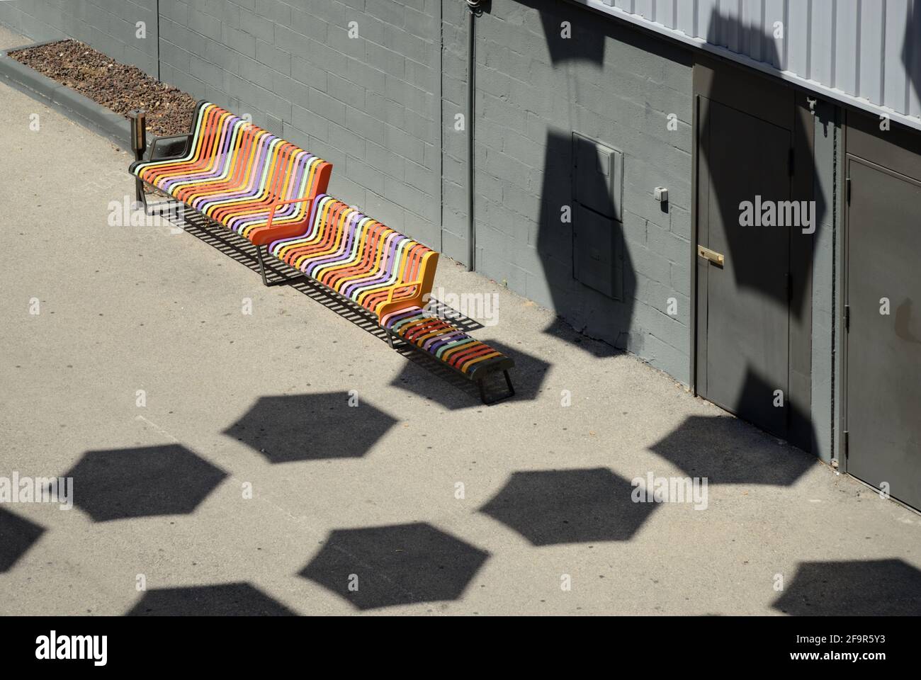 Abstrakte Straßenmuster mit mehrfarbiger Metallbank oder bunter Straße Möbel und Schatten von Parasols Aix-en-Provence Frankreich Stockfoto