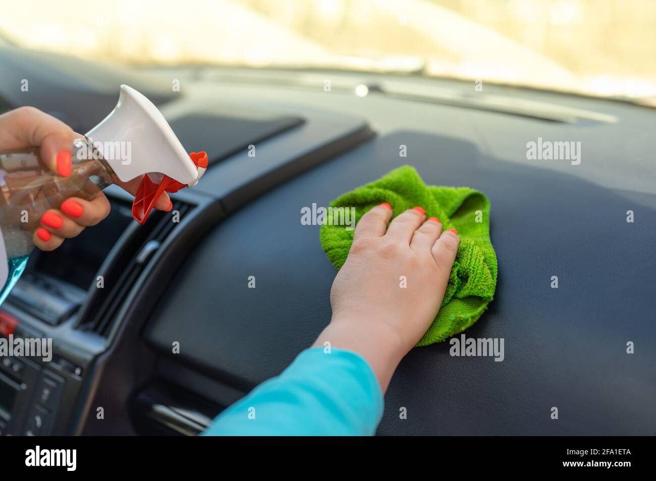 Frau Reinigung ihres Auto-Cockpit mit Spray und Mikrofaser Tuch. Wischen  Sie das Auto mit Tuch und Polieren Wachsen reinigen Stockfotografie - Alamy