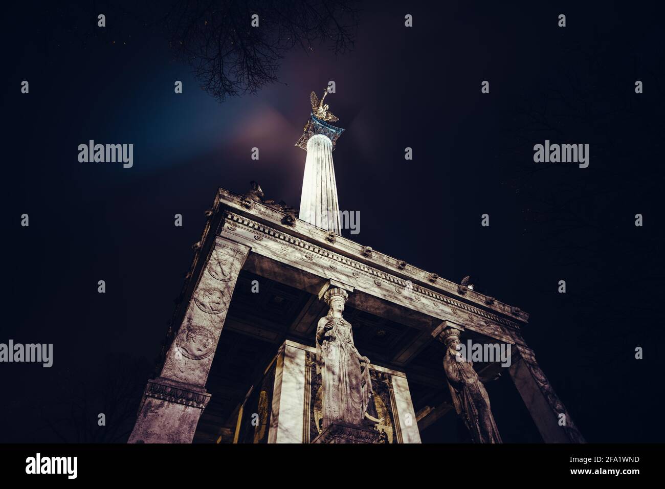 Das Friedensengel in München bei Nacht. Ein Denkmal mit einem goldenen Engel auf der Oberseite, Mosaiksteinen und einigen Statuen. Erbaut während der Barockepoche. Stockfoto