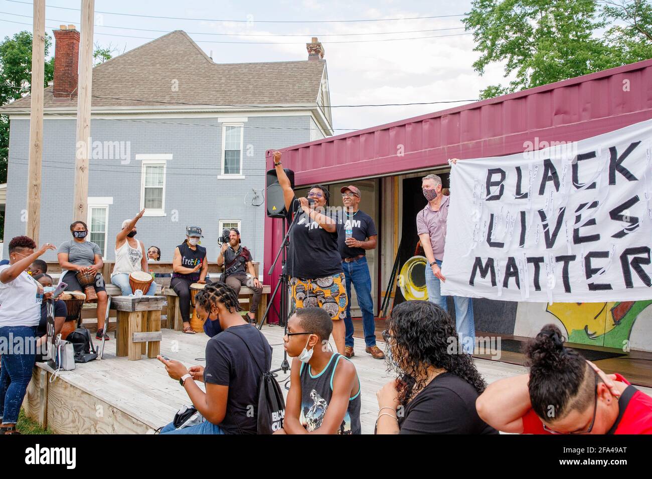Eine Frau steht auf der Bühne beim Protest von Black Lives Matter Mit Mikrofon Stockfoto