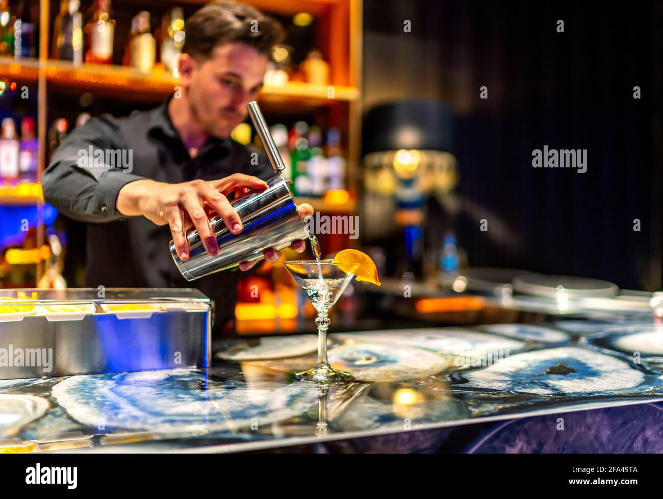 Kellner serviert einen leckeren Cocktail an seinem Platz Stockfoto