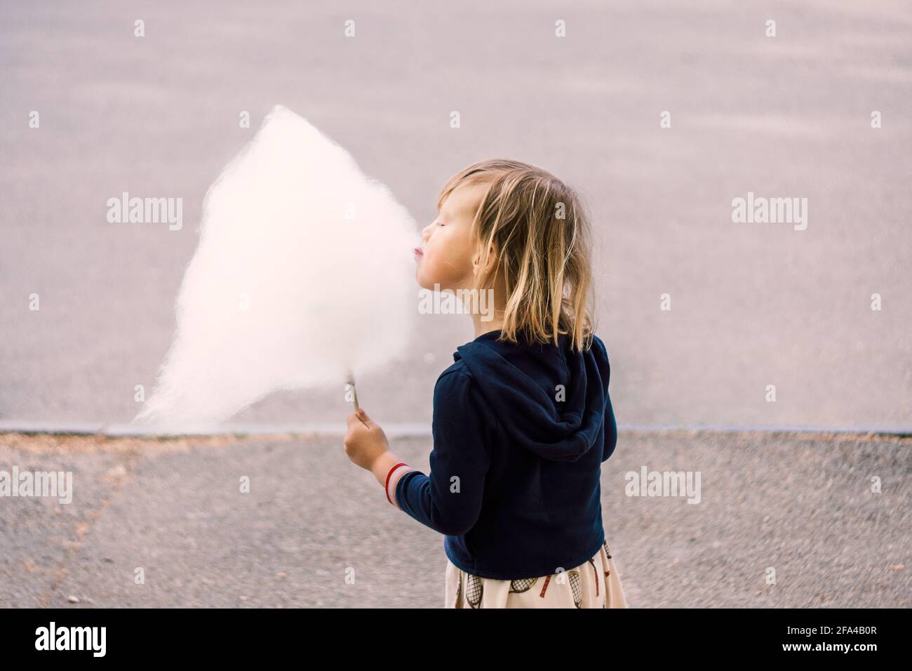 Nettes junges Mädchen 3-4 Jahre alt essen Baumwolle Süßigkeiten Stockfoto