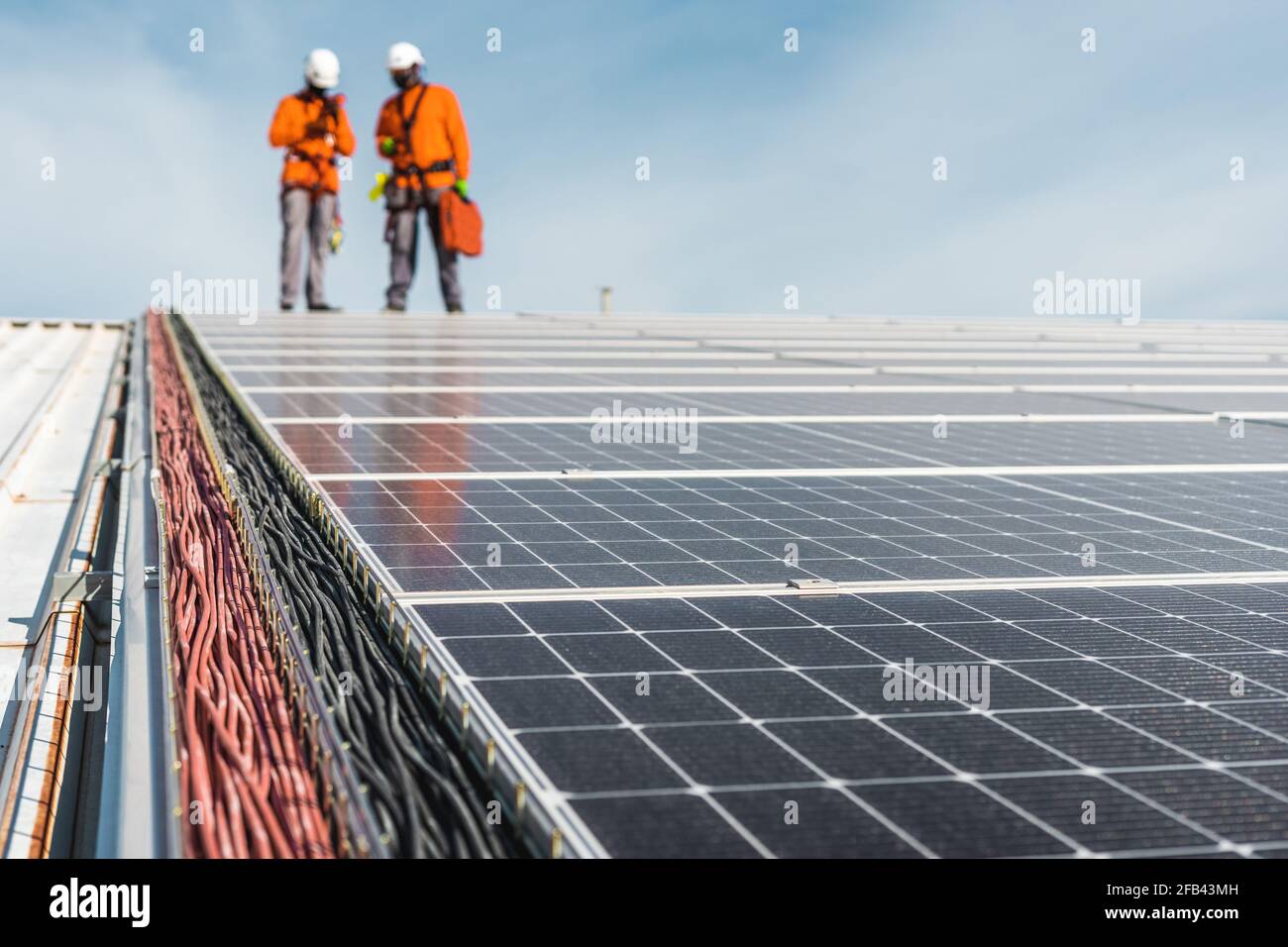Solarpanel-Installation mit unkenntlichen Technikern auf der Oberseite Stockfoto