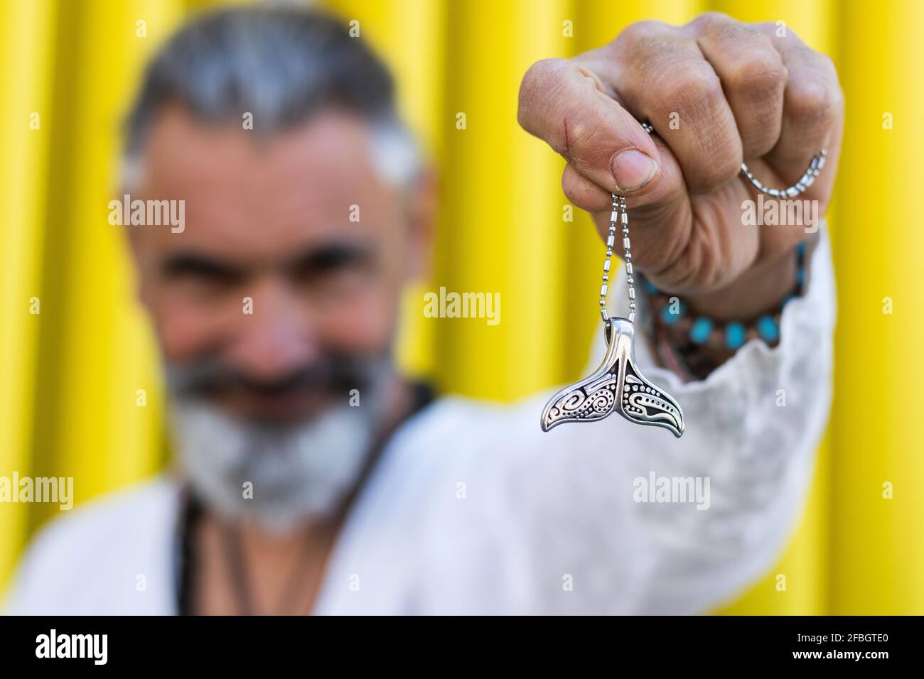 Mann mit Fischschwanz-Medaillon Stockfoto