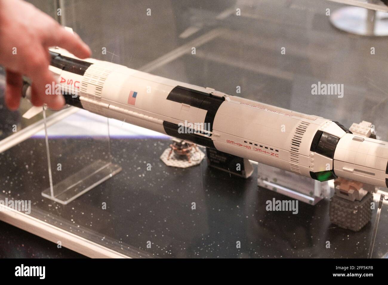 Shanghai, China. April 2021. Ein Einkäufer zeigt auf eine Nachbildung der Saturn 5 Rakete, die in Lego in einem Flaggschiff des Lego-Stores auf dem Shanghai People's Square gebaut wurde. Kredit: Thibaud Mougin/SOPA Images/ZUMA Wire/Alamy Live Nachrichten Stockfoto