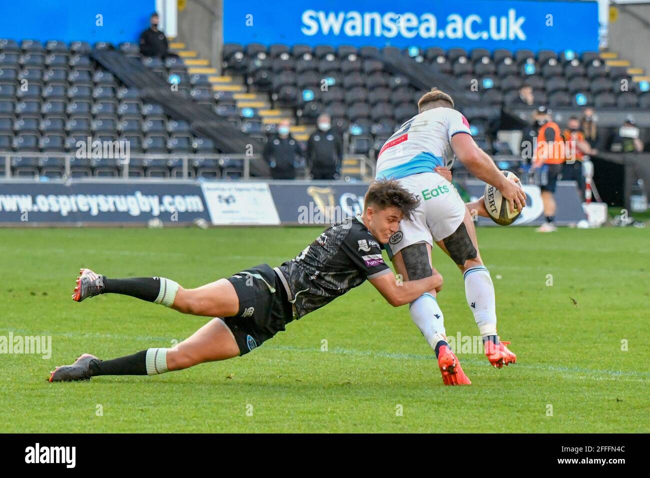 Swansea, Großbritannien. April 2021. Owen Lane von Cardiff Blues wird von Reuben Morgan-Williams von Ospreys während des Guinness PRO14 Rainbow Cup-Spiels zwischen Ospreys und Cardiff Blues am 24. April 2021 im Liberty Stadium in Swansea, Wales, Großbritannien, angegangen. Sportstadien in ganz Großbritannien unterliegen aufgrund der Coronavirus-Pandemie weiterhin strengen Beschränkungen, da staatliche Gesetze zur sozialen Distanzierung Fans innerhalb von Veranstaltungsorten verbieten, was dazu führt, dass Spiele hinter verschlossenen Türen gespielt werden. Quelle: Duncan Thomas/Majestic Media/Alamy Live News. Stockfoto
