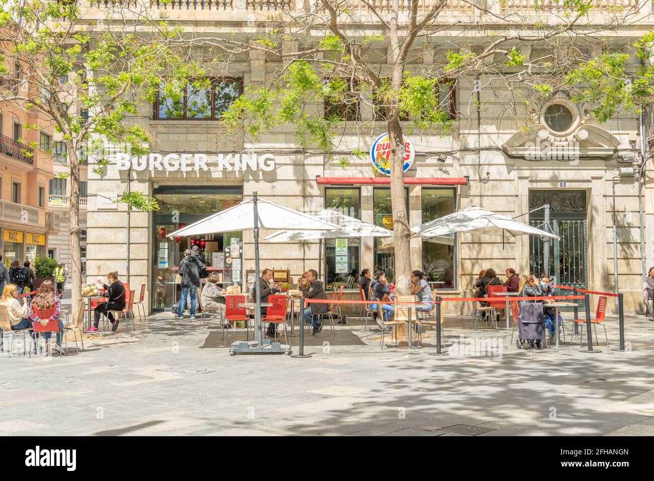 Palma de Mallorca, Spanien; april 23 2021: Hauptfassade des Franchise-Restaurants Burguer King an der Plaza de España. Bürger tragen Gesichtsmasken aufgrund der Stockfoto