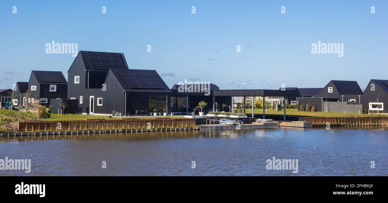 Panorama von schwarzen Häusern am Kai in Blauwestad, Niederlande Stockfoto